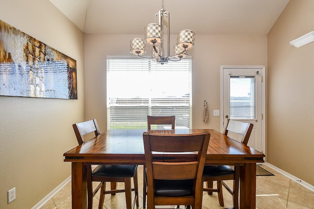 dining area with baseboards and a chandelier