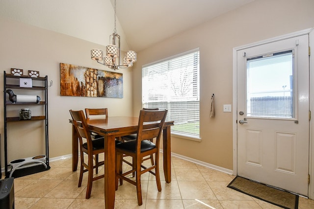 dining space with light tile patterned floors, baseboards, lofted ceiling, and a chandelier