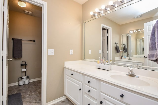 bathroom featuring visible vents, vanity, and baseboards