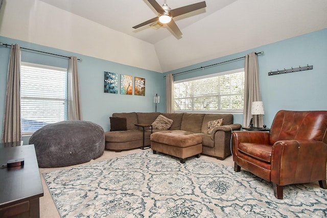 carpeted living area featuring a wealth of natural light, a ceiling fan, and vaulted ceiling