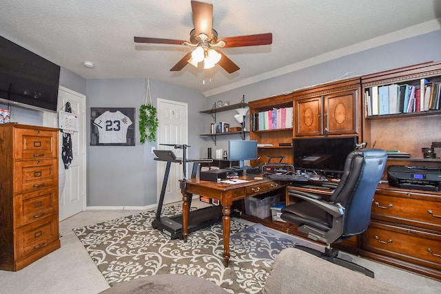 home office featuring a textured ceiling, light colored carpet, baseboards, and ceiling fan