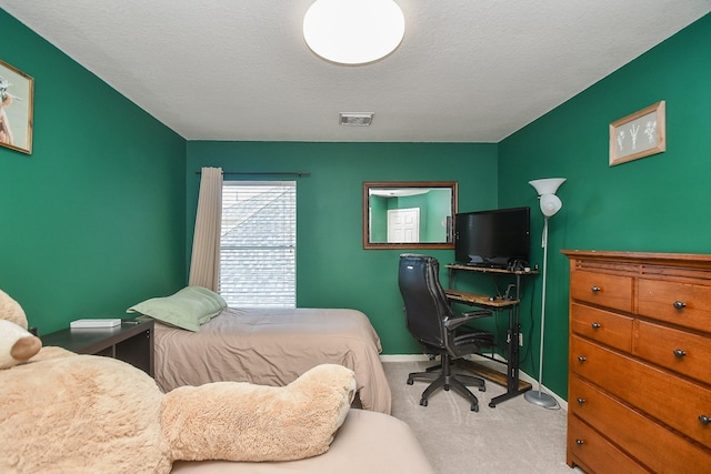 bedroom with visible vents, baseboards, a textured ceiling, and carpet flooring