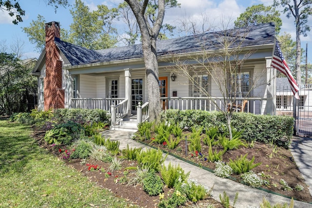 view of front of property featuring a porch and a chimney