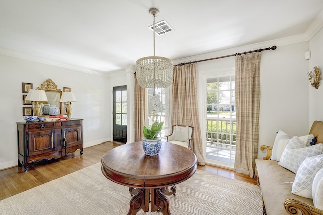 dining space featuring plenty of natural light, an inviting chandelier, and wood finished floors