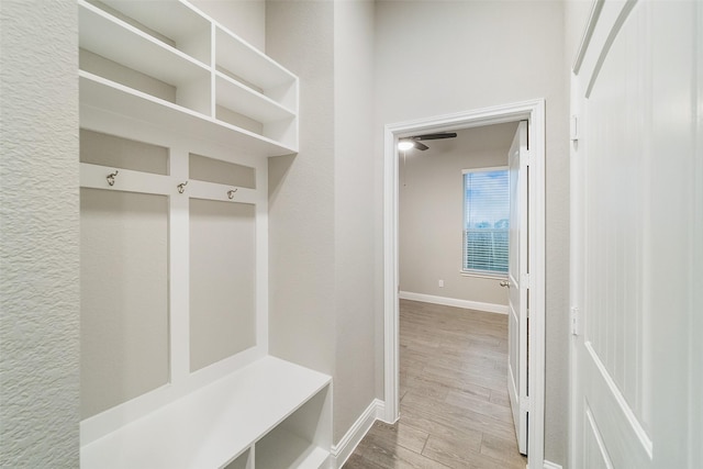 mudroom with baseboards and wood finished floors