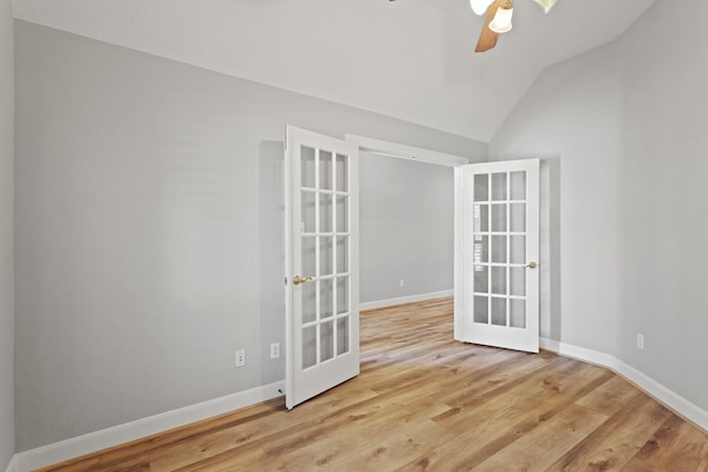 spare room with wood finished floors, french doors, and baseboards