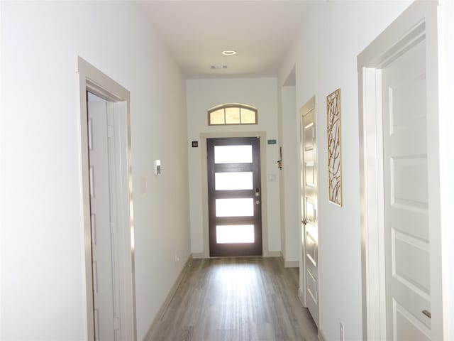 entrance foyer with visible vents, baseboards, and light wood finished floors