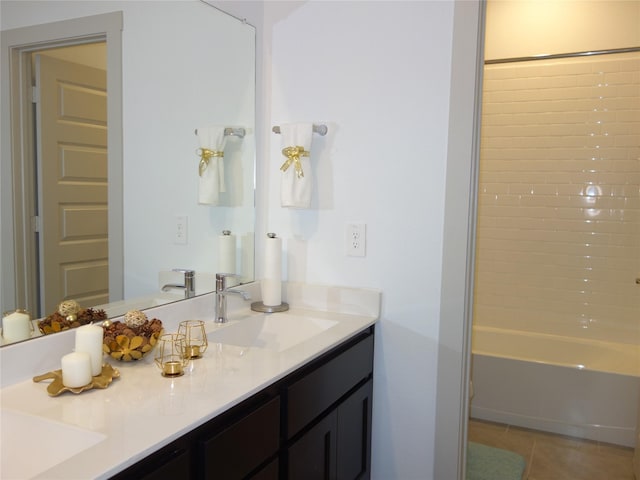 full bathroom featuring a sink, double vanity, and tile patterned floors