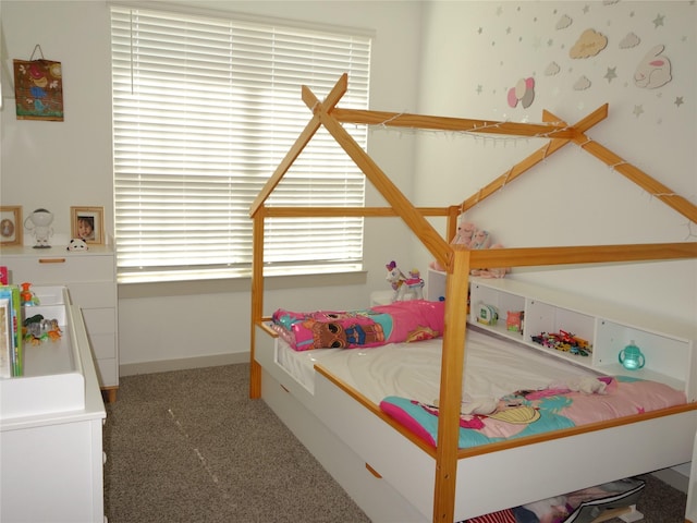 bedroom featuring baseboards and carpet flooring