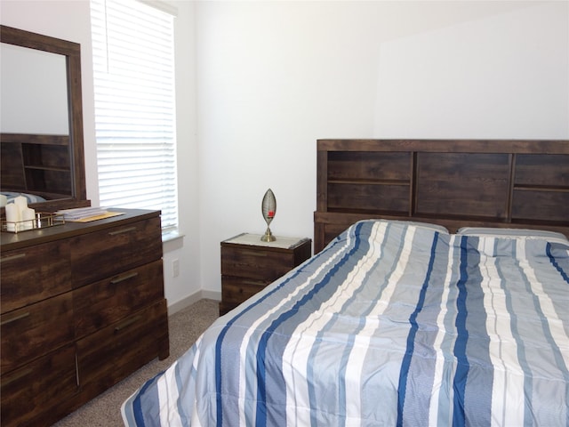 bedroom with baseboards and carpet floors