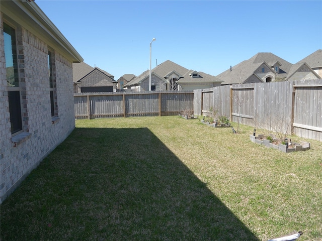 view of yard with a fenced backyard and a vegetable garden