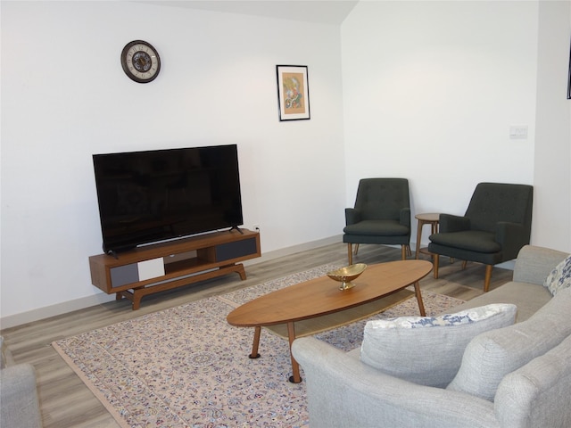 living room with baseboards and wood finished floors