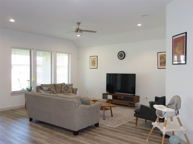 living area featuring baseboards, recessed lighting, ceiling fan, vaulted ceiling, and light wood-style floors