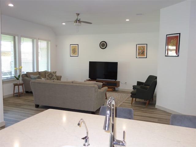 living area featuring recessed lighting, baseboards, and wood finished floors