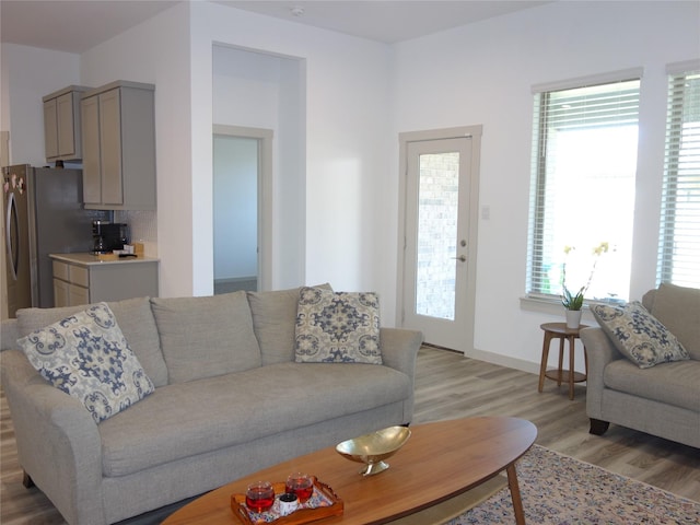 living room featuring baseboards and light wood finished floors