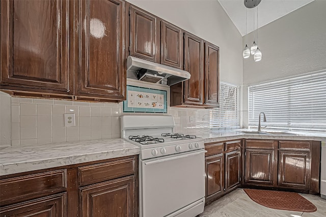 kitchen with a sink, vaulted ceiling, dark brown cabinets, under cabinet range hood, and white gas range