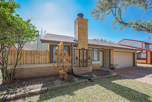 view of front of house with fence, roof with shingles, driveway, a chimney, and a garage