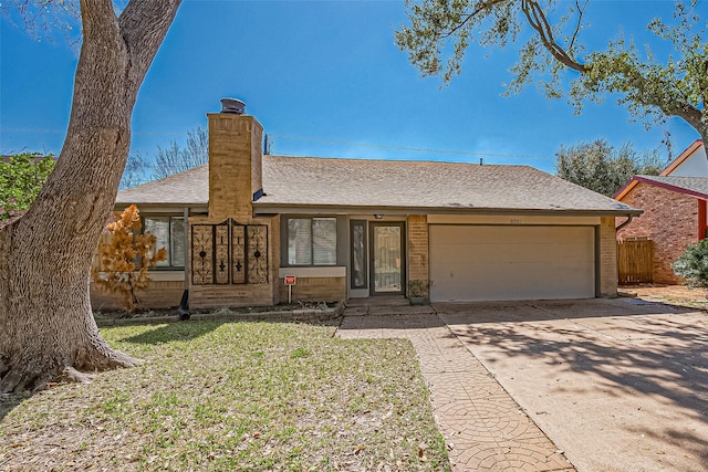 ranch-style home featuring brick siding, a shingled roof, a chimney, a garage, and driveway