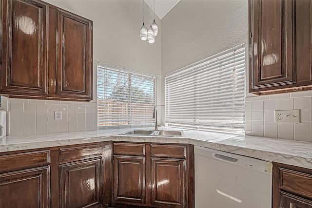 kitchen featuring a sink, dark brown cabinets, and white dishwasher