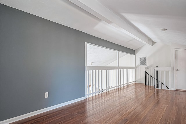 bonus room featuring hardwood / wood-style floors, vaulted ceiling with beams, and baseboards