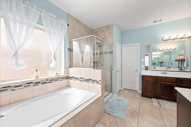 bathroom with visible vents, a stall shower, tile patterned flooring, a bath, and vanity