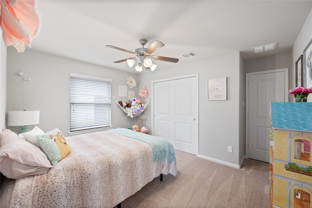 carpeted bedroom featuring a closet, ceiling fan, and baseboards