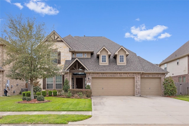 view of front of property with brick siding, a shingled roof, concrete driveway, a front yard, and a garage