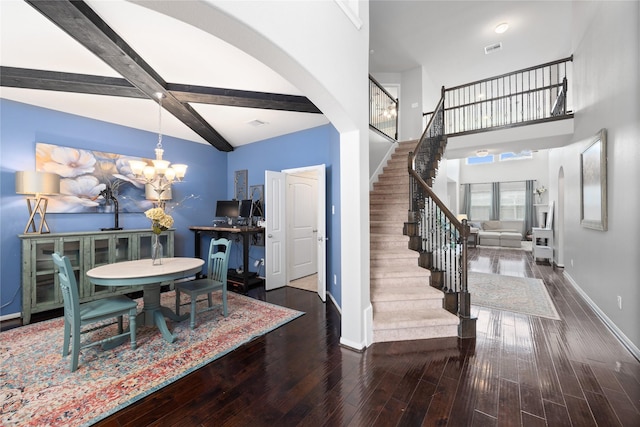 dining space with beam ceiling, an inviting chandelier, baseboards, and wood finished floors