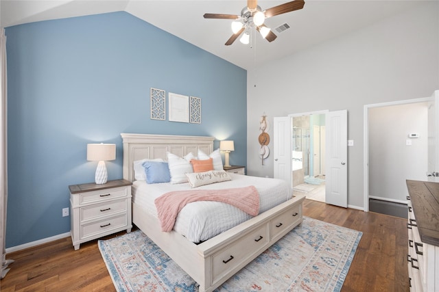 bedroom with lofted ceiling, dark wood-style floors, visible vents, and baseboards