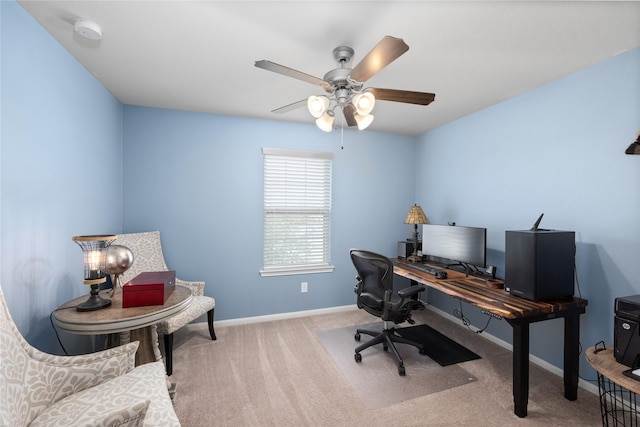 carpeted home office with a ceiling fan and baseboards