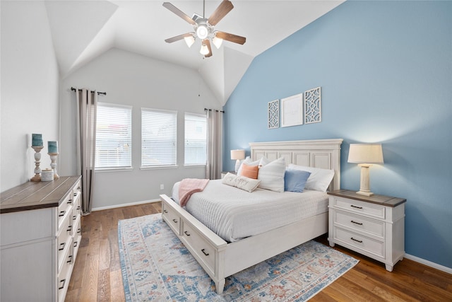 bedroom featuring baseboards, a ceiling fan, lofted ceiling, and wood finished floors