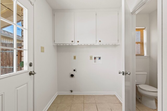 clothes washing area with baseboards, washer hookup, light tile patterned floors, cabinet space, and hookup for an electric dryer