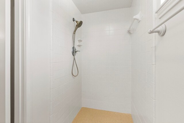 bathroom with a tile shower