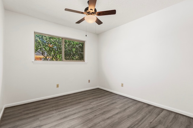 unfurnished room with a ceiling fan, baseboards, and wood finished floors