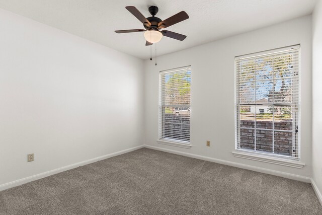 unfurnished room featuring baseboards, carpet floors, and ceiling fan