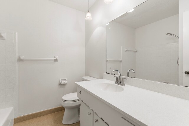 bathroom featuring vanity, toilet, and baseboards