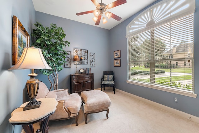 sitting room with carpet flooring, a ceiling fan, and baseboards