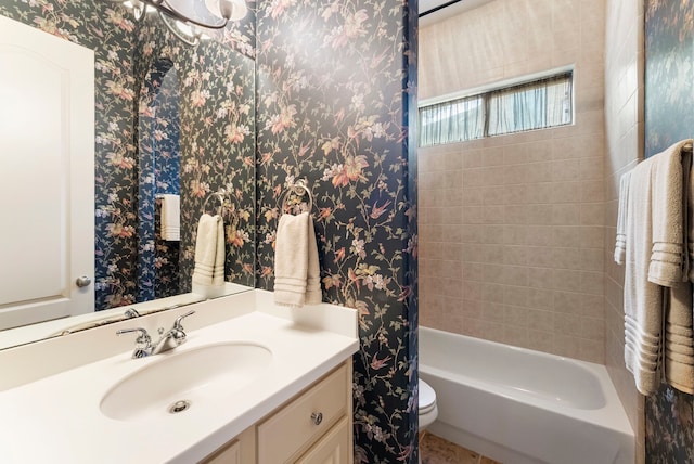 full bathroom featuring toilet, wallpapered walls, and vanity