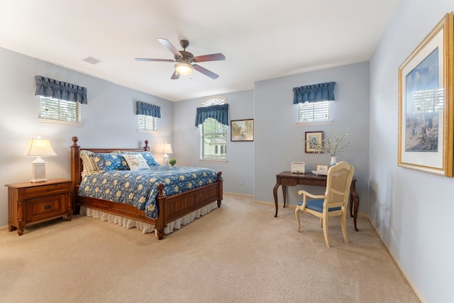 bedroom featuring baseboards, visible vents, and light carpet