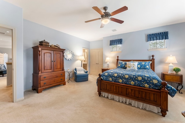 bedroom with visible vents, light carpet, baseboards, and ceiling fan