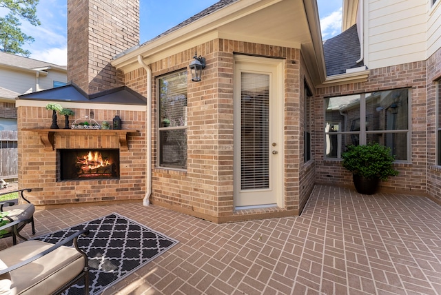 view of patio with an outdoor brick fireplace