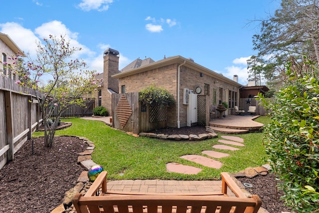 view of yard with a fenced backyard and a patio