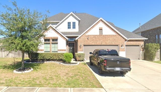 view of front of property with a shingled roof, concrete driveway, a front lawn, a garage, and brick siding