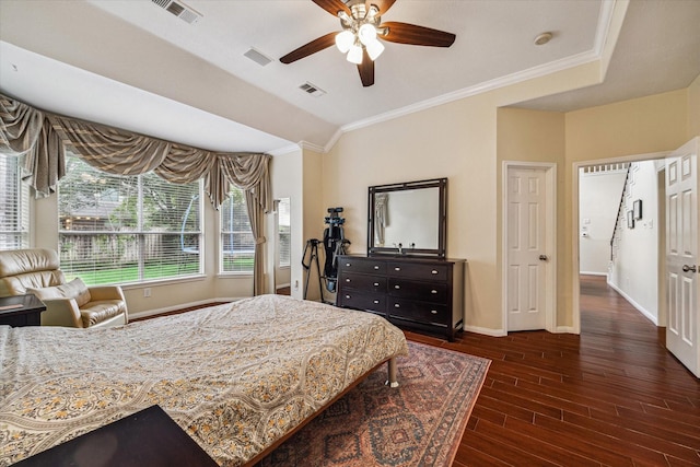 bedroom with crown molding, wood finished floors, visible vents, and baseboards