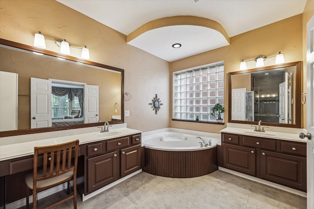 full bathroom with a sink, a stall shower, and a wealth of natural light