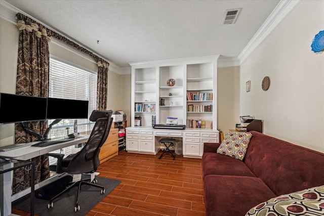 office with visible vents, a textured ceiling, crown molding, and wood tiled floor