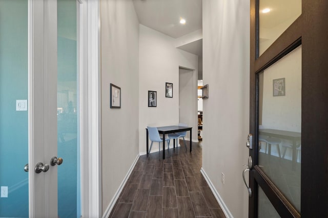 hallway with baseboards and wood tiled floor