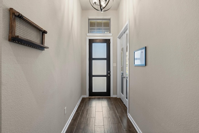 doorway featuring baseboards and wood tiled floor