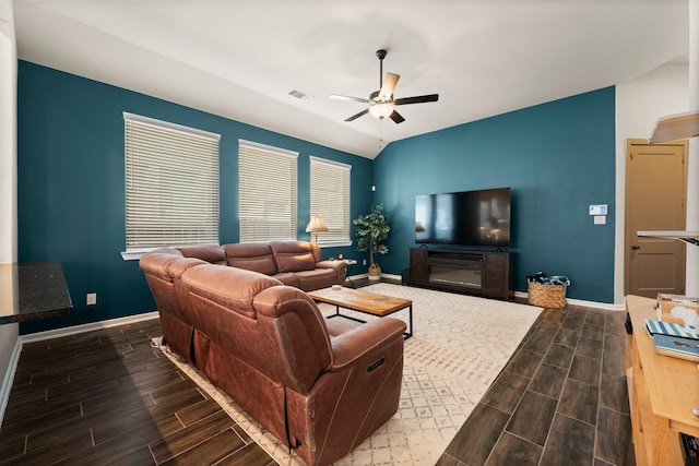 living room with wood finish floors, visible vents, baseboards, and a ceiling fan