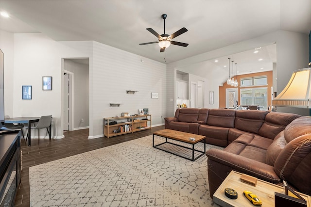 living room featuring recessed lighting, wood finished floors, baseboards, and vaulted ceiling